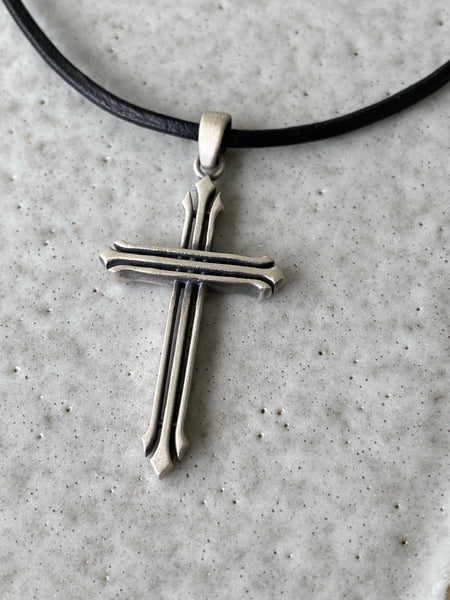 Silver cross necklace with a black leather cord 