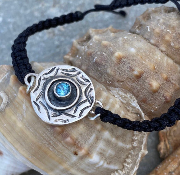 Silver evil eye bracelet with a blue gemstone