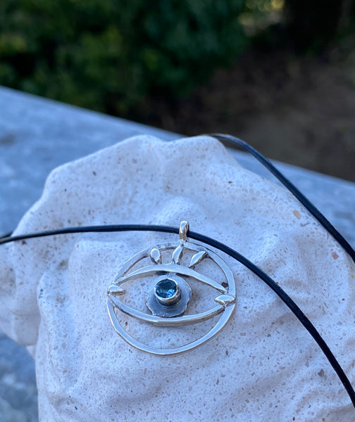 Evil eye necklace with blue gemstone and leather cord