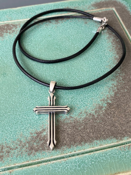 Silver cross necklace with a black leather cord 