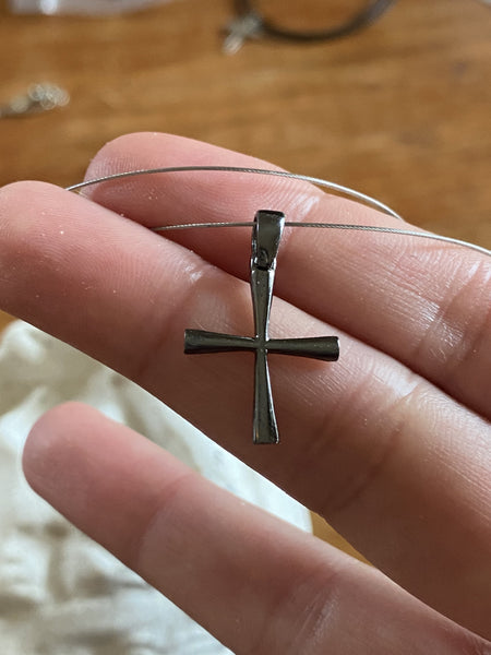 small black cross, woman’s silver cross 